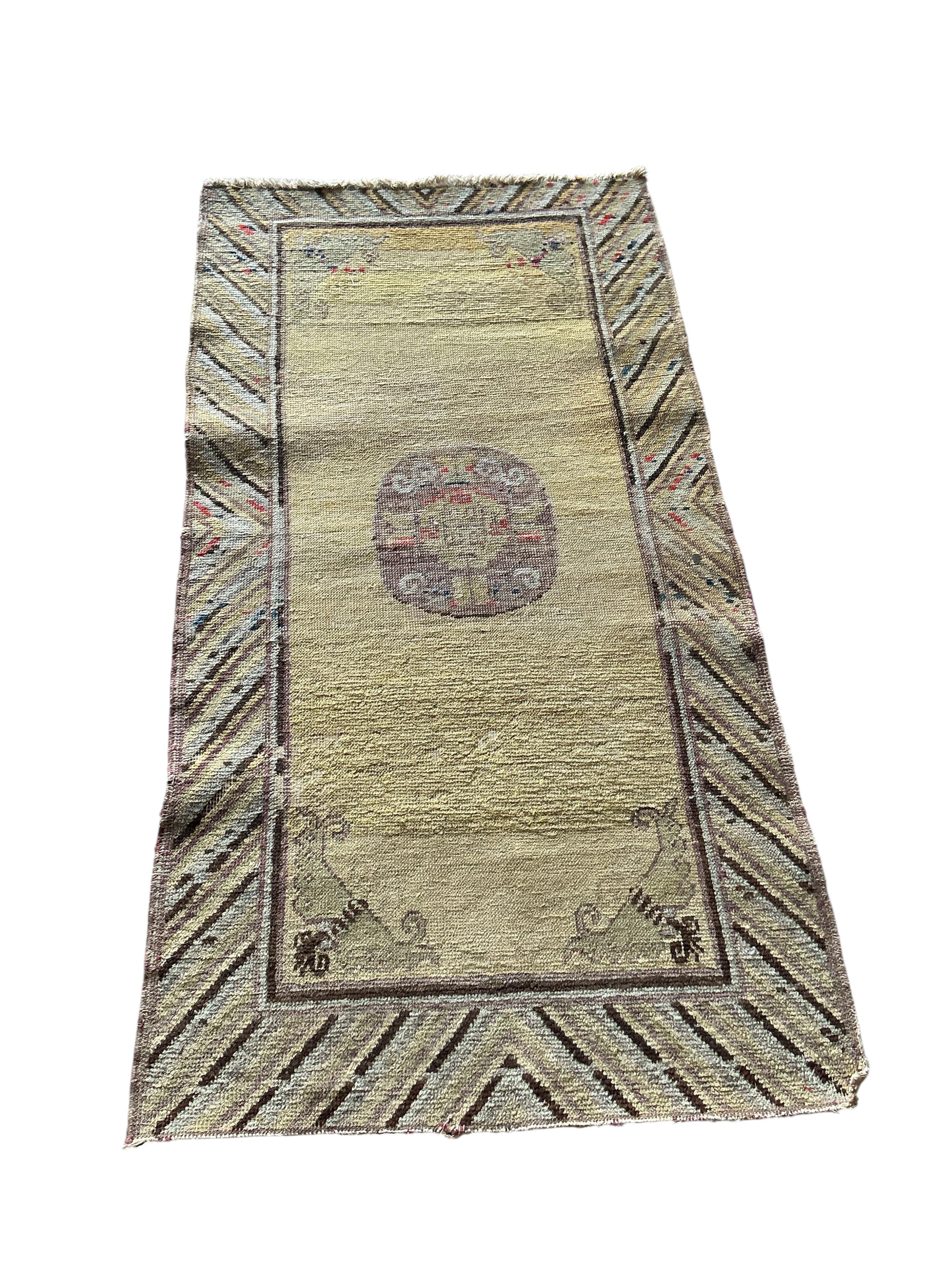 A Tibetan yellow ground rug, 134 x 70cm